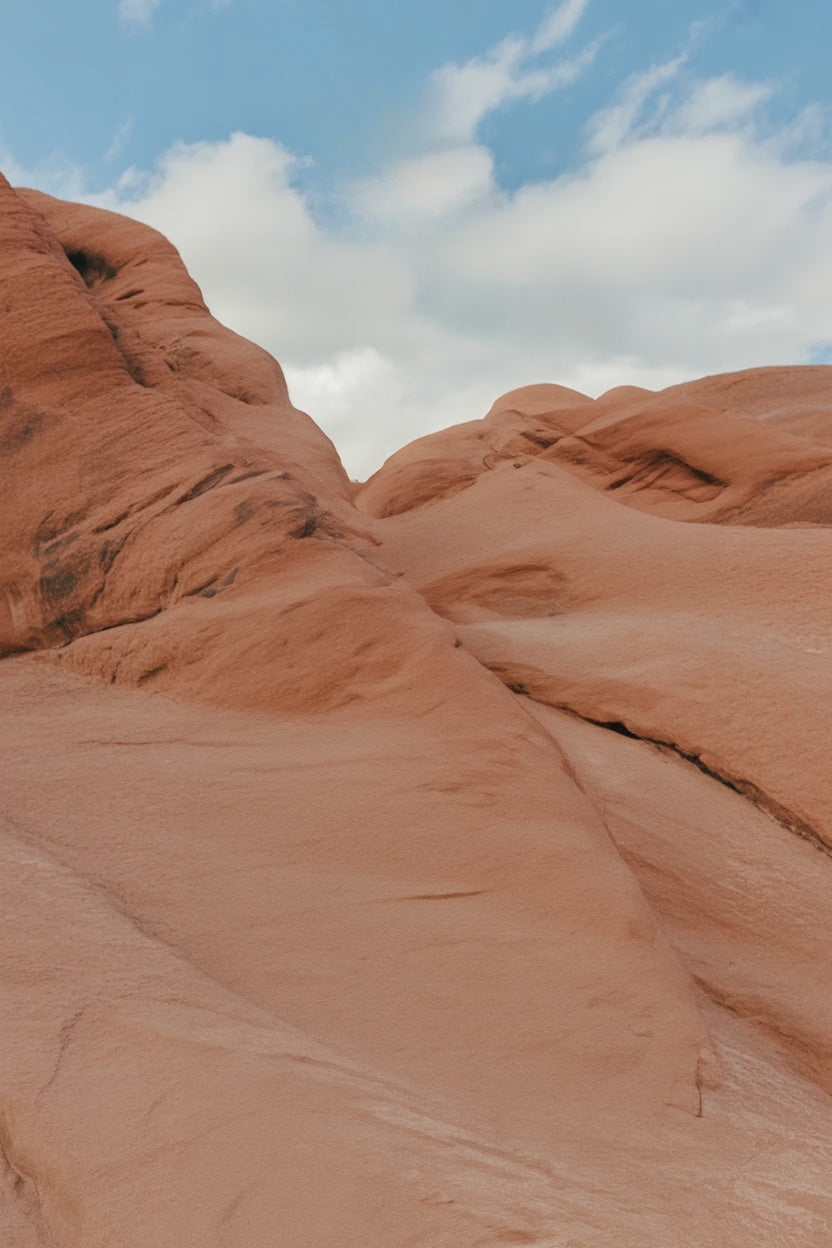 Red sandstone rock formations under a bright blue sky