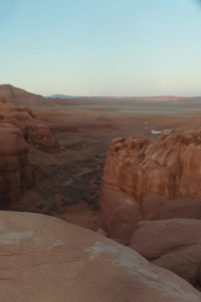 Expansive desert canyon landscape with red rock formations