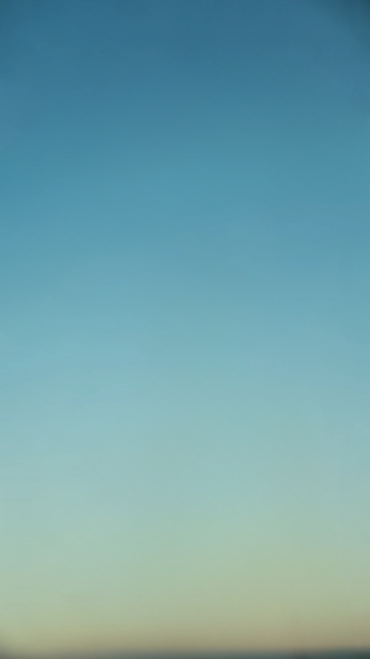 Clear blue sky with soft gradient and distant horizon