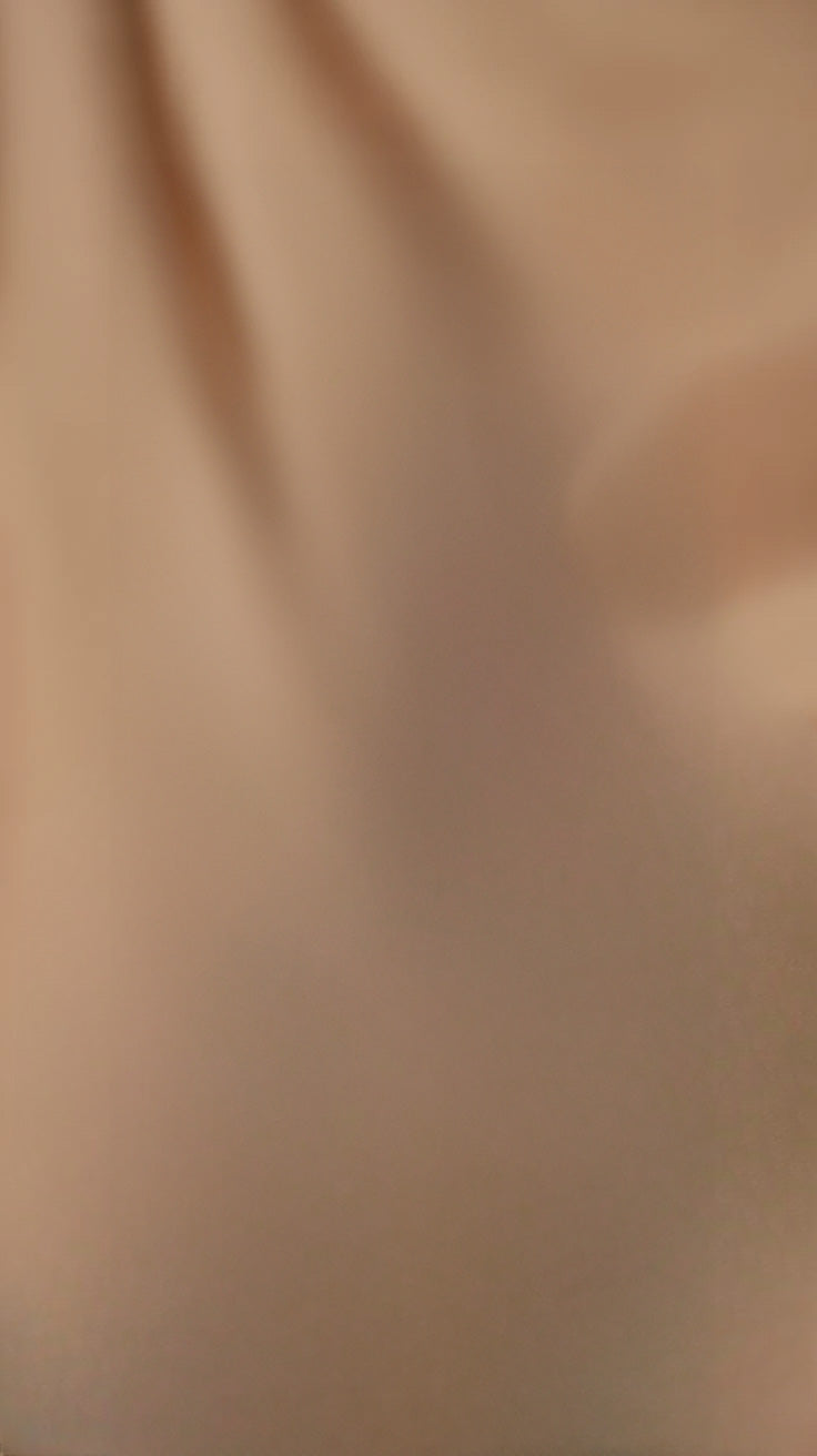 Soft flowing fabric texture with gentle light and shadows