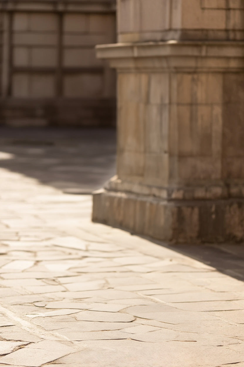 Historic stone courtyard with weathered architectural columns and pavement