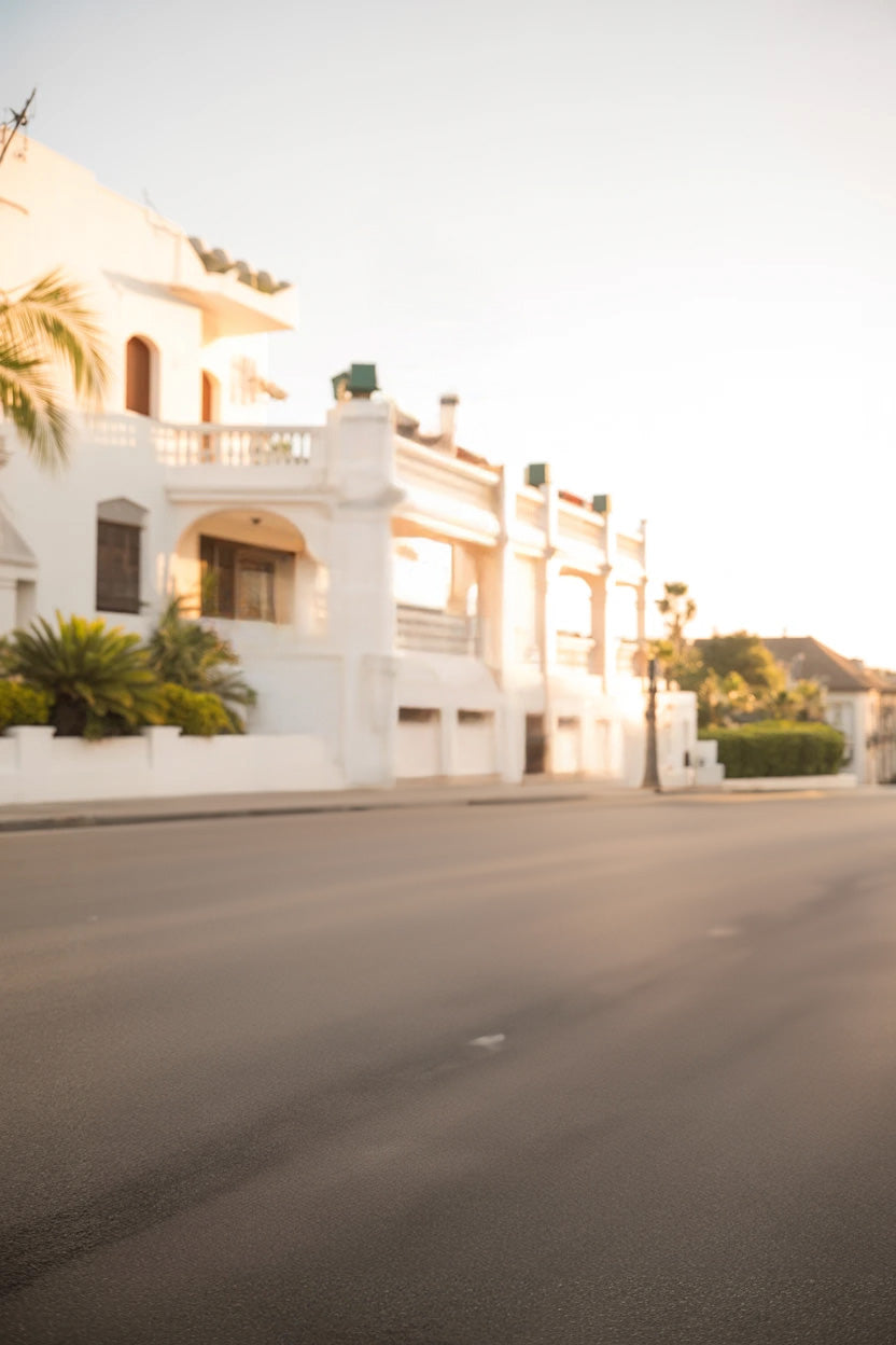 Sunny street with white Mediterranean-style residential buildings
