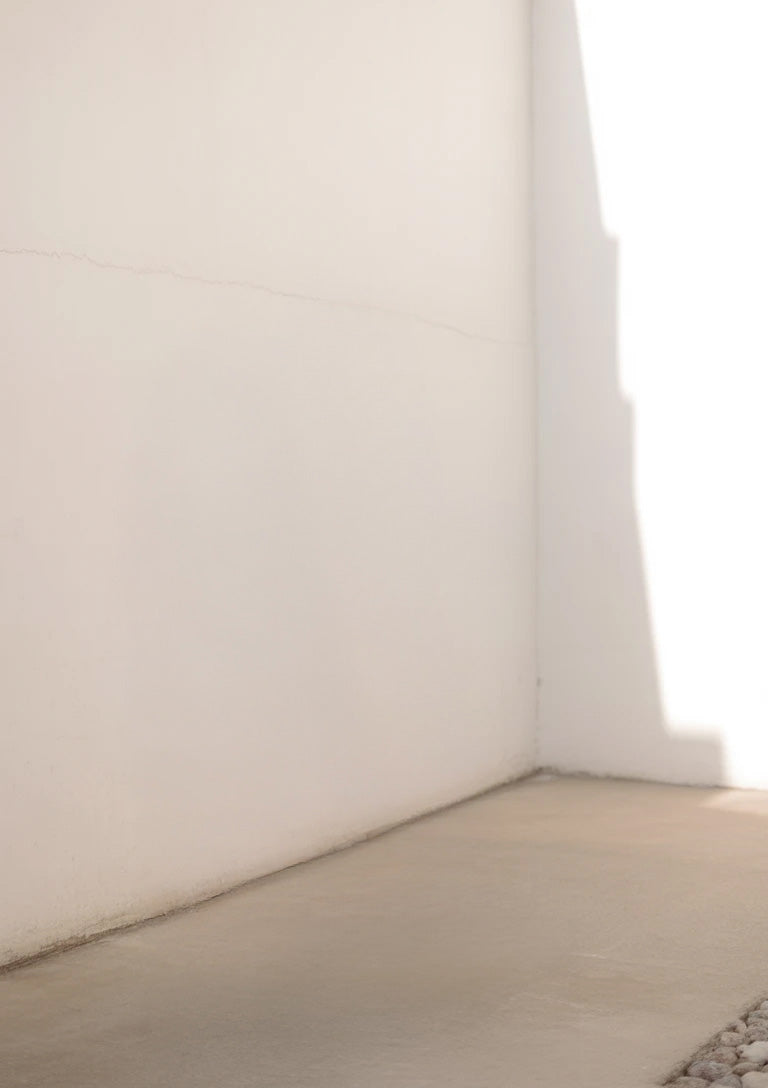 White wall corner with sunlight casting strong shadow