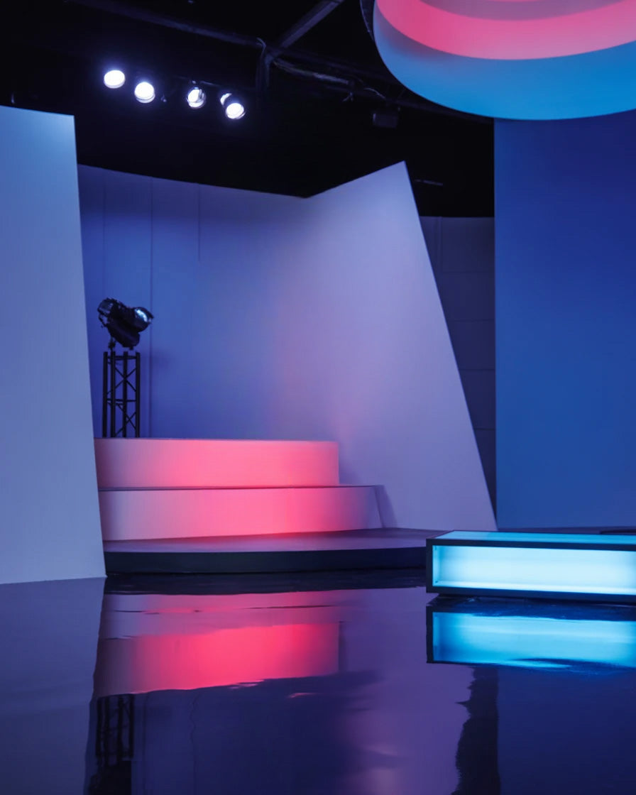Modern stage with geometric panels and colorful ambient lighting