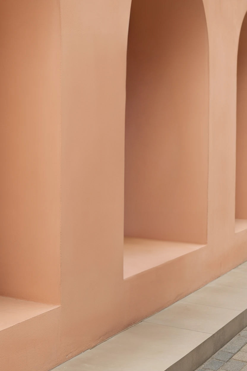 Soft peach arched wall with tiled walkway base