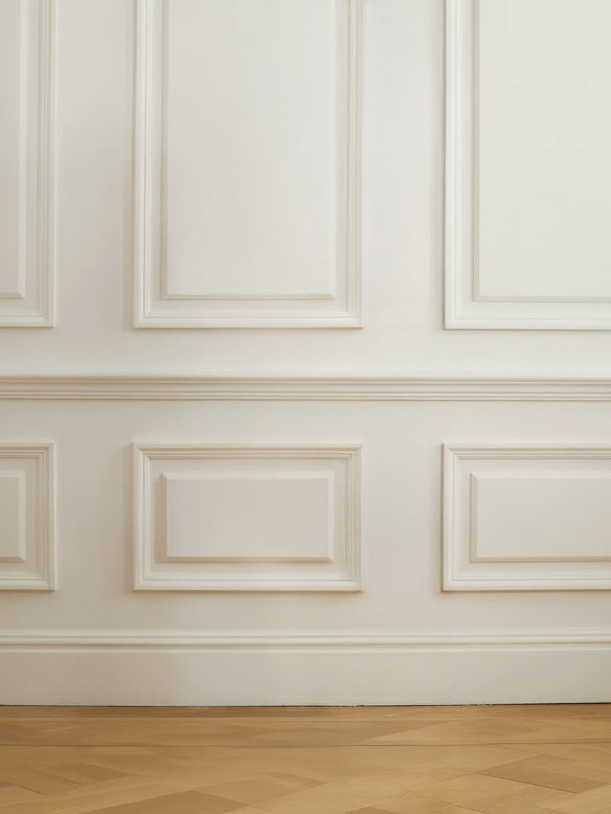 Elegant white paneled wall with polished wooden floor
