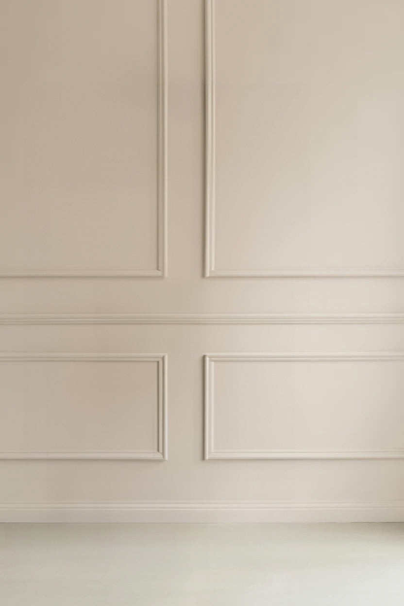 Beige wall with decorative rectangular molding and trim