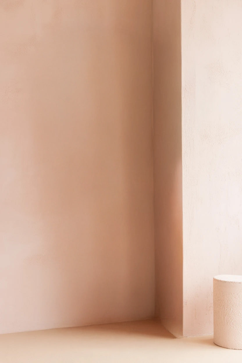 Minimal corner with soft beige walls and pedestal