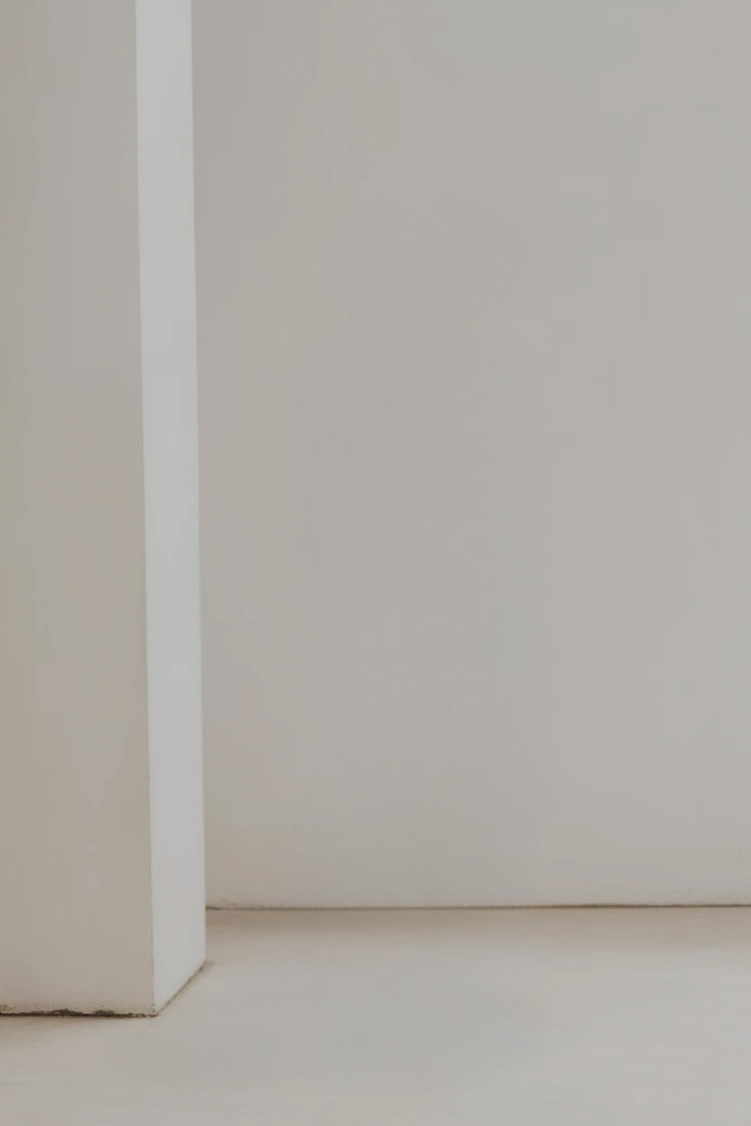 Minimalist white corner wall with smooth concrete floor