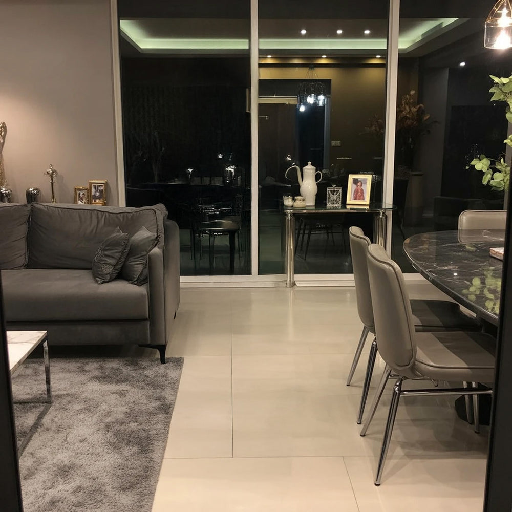 Modern living and dining area with glass doors and neutral tones