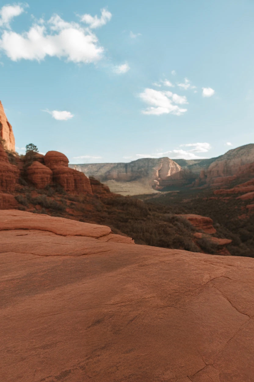 Red rock canyon landscape with blue sky and clouds