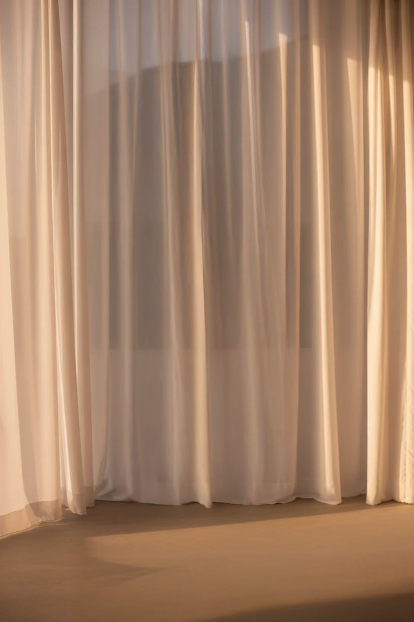 Soft sheer curtains with warm sunlight gently filtering through
