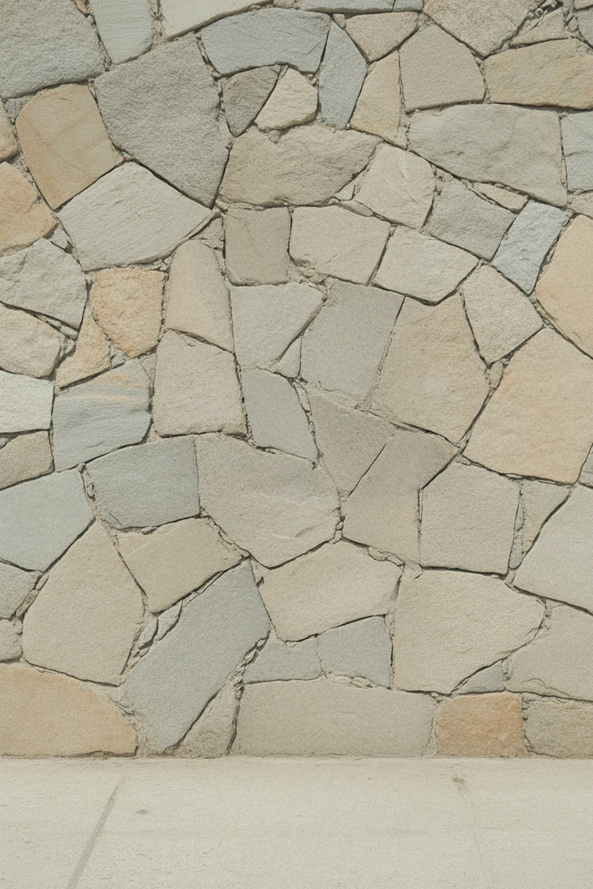 Stone wall with irregular beige and gray rock pattern