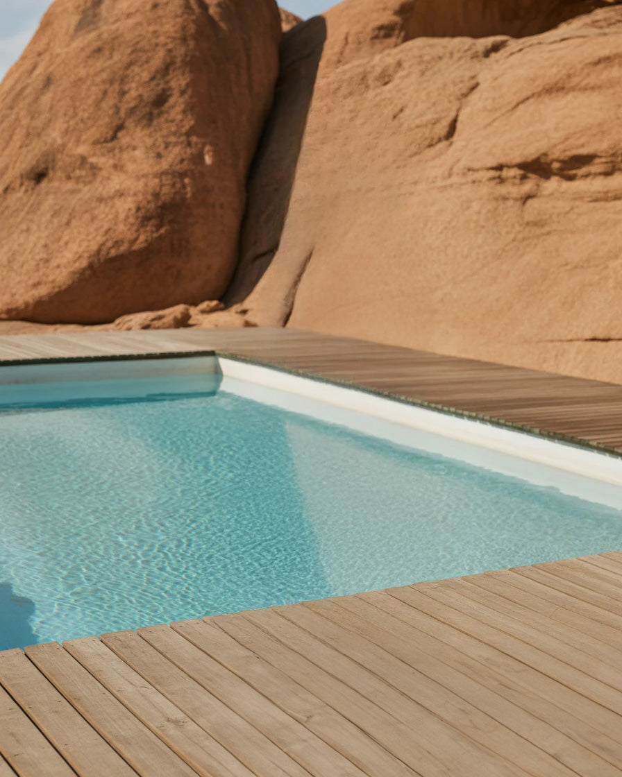 Modern poolside deck surrounded by warm desert rock formations