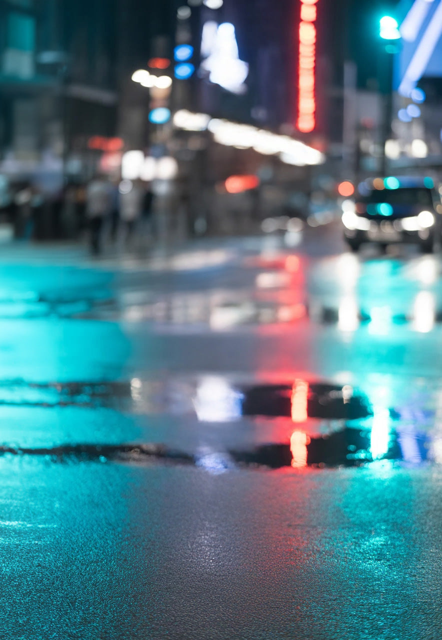 Wet city street with colorful neon lights reflecting at night