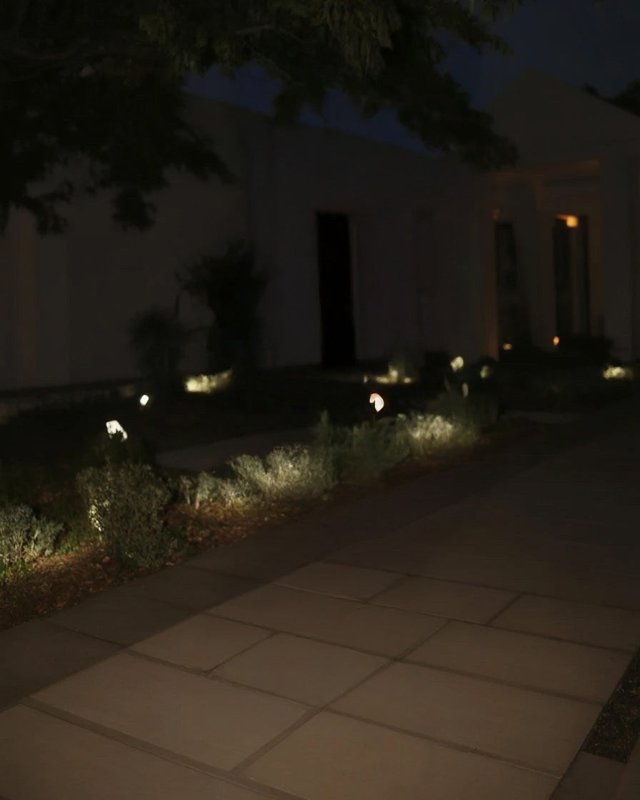 Modern garden walkway illuminated with soft landscape lighting
