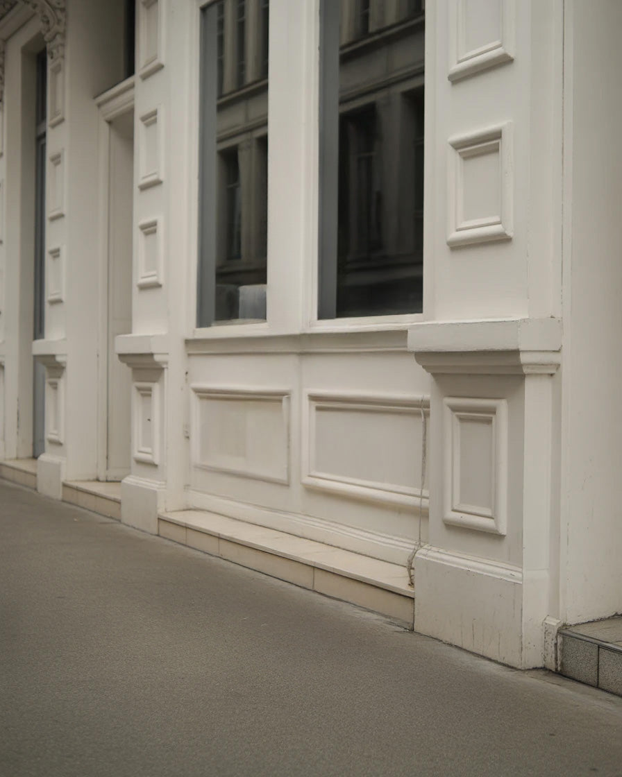 Classic white building facade with large windows and molding