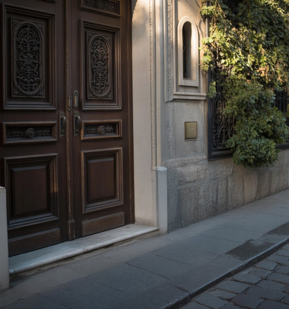 Elegant carved wooden doors with stone facade and vines