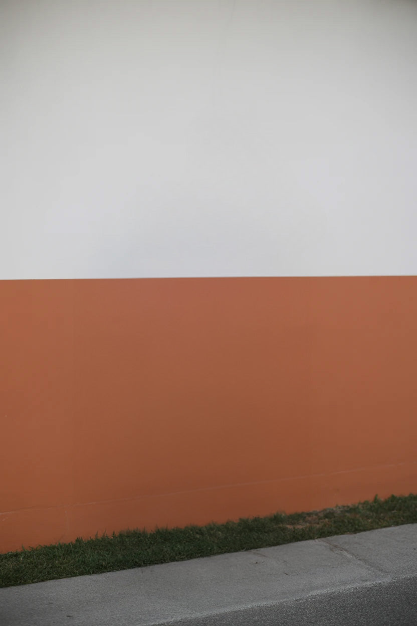 Two-tone orange and white wall with grass edging