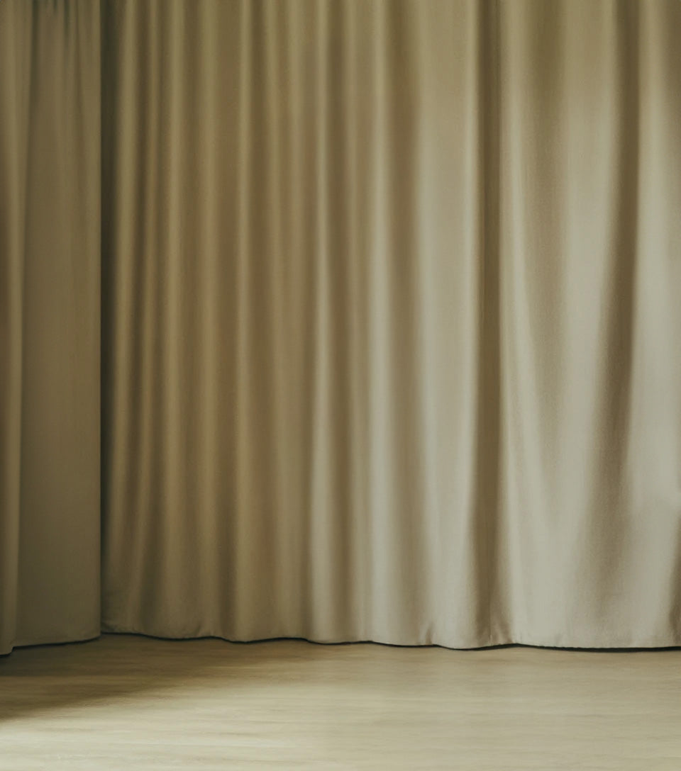 Beige floor-length curtains with soft natural lighting