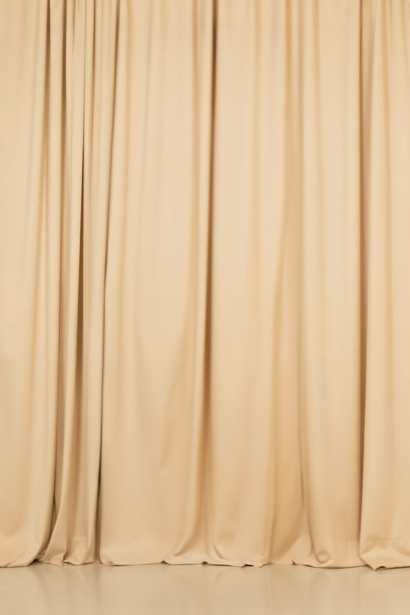 Beige floor-length curtains with soft folds and shadows