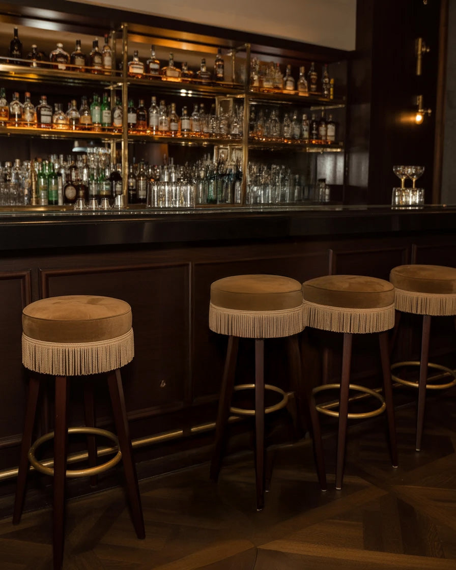 Elegant bar interior with wooden stools and liquor display shelves