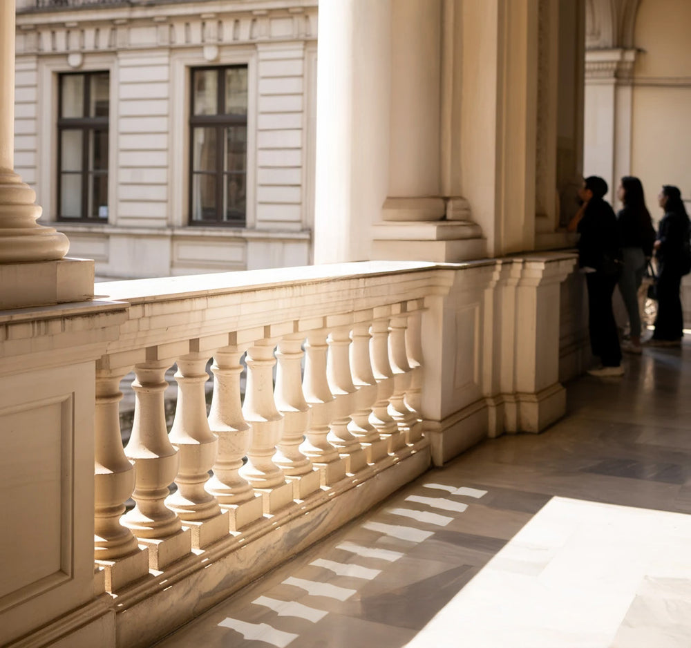 Elegant stone balcony with classical balustrade and arched columns