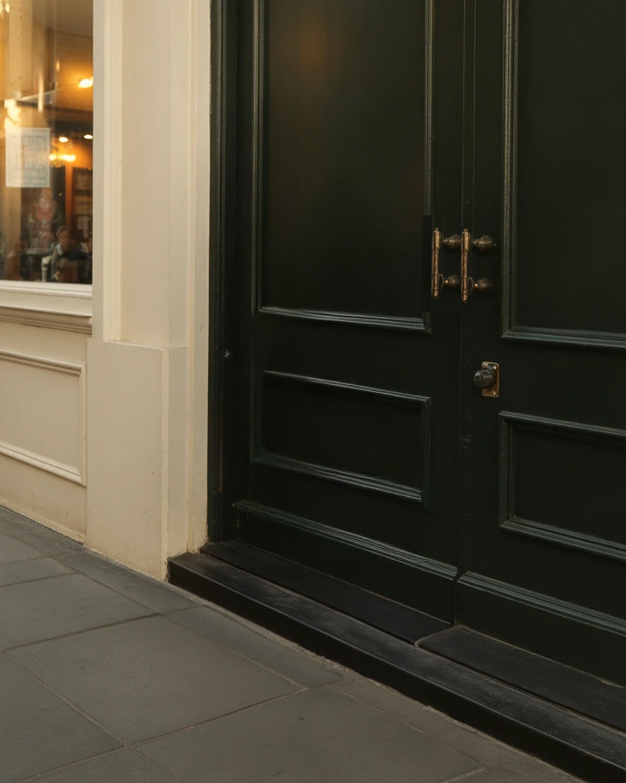 Classic dark wooden double doors with brass handles