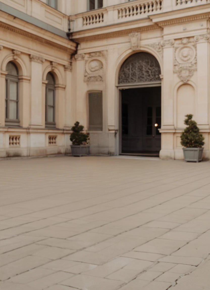 Elegant courtyard with arched doorway and classic stone facade