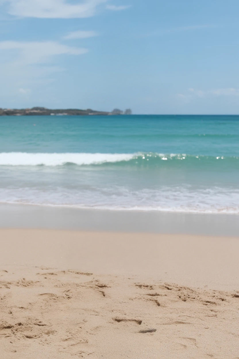 Clear turquoise waves gently reaching the sandy beach shore