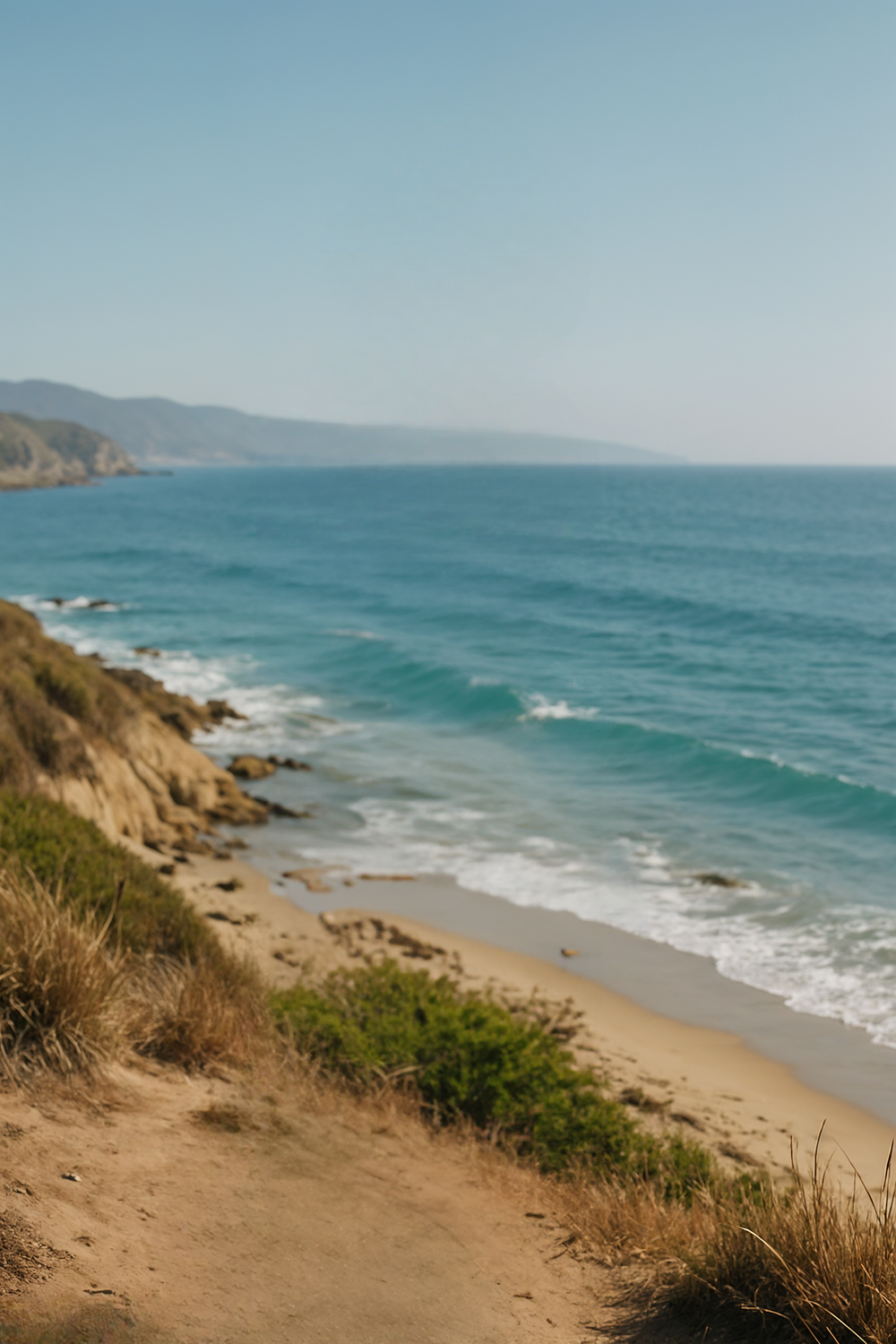Coastal cliffs meeting calm blue ocean horizon line