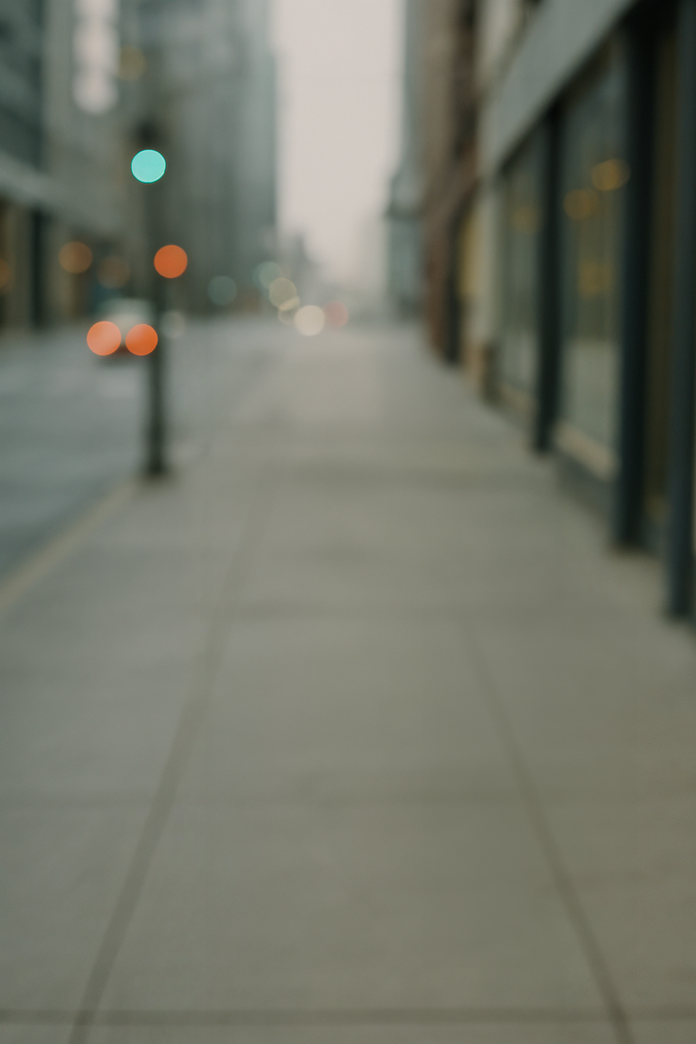 Urban street scene with tall buildings and soft bokeh lighting