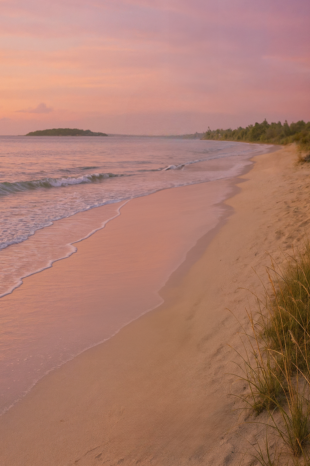 Pastel sunset sky over quiet tropical beach shoreline