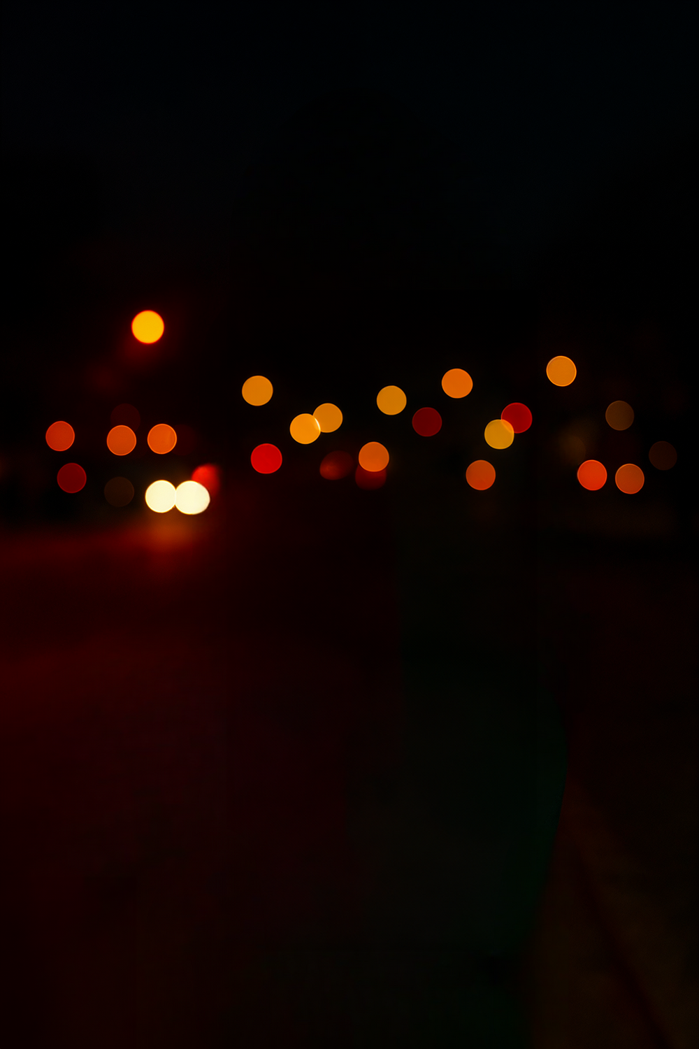 City street at night with red and orange bokeh lights