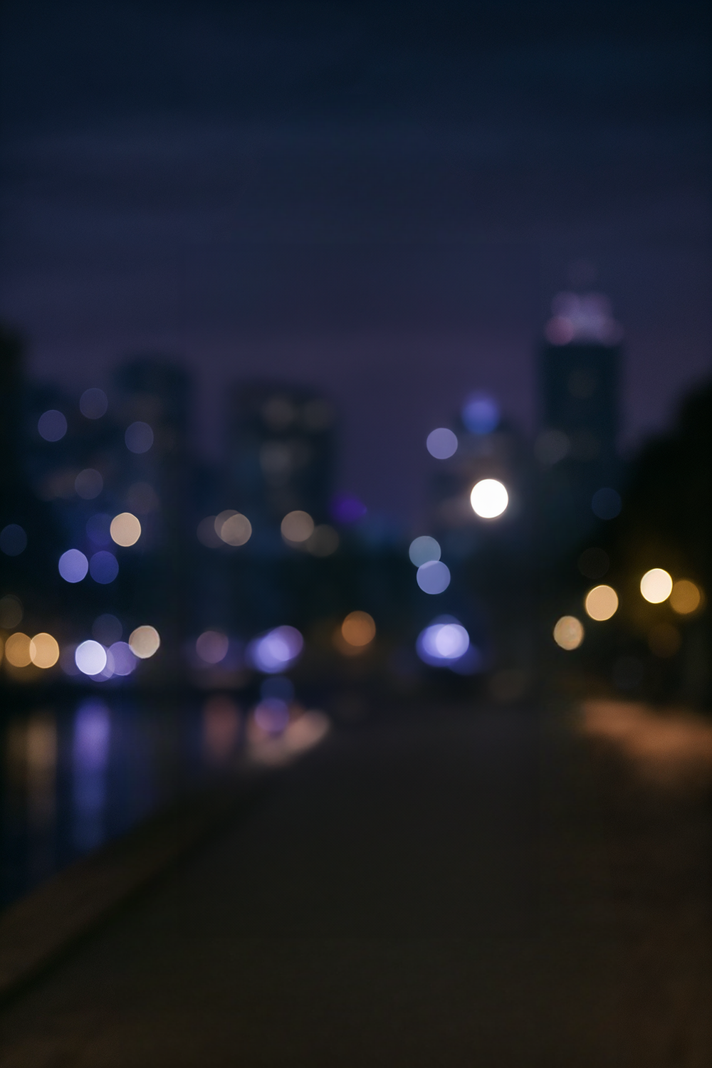 City skyline and waterfront promenade at twilight hour