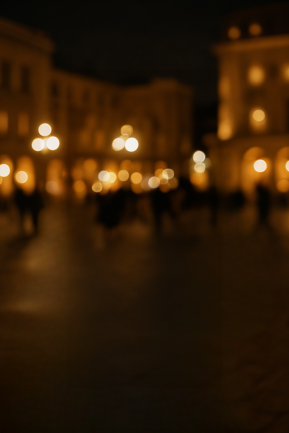 Elegant European plaza at night with warm streetlights