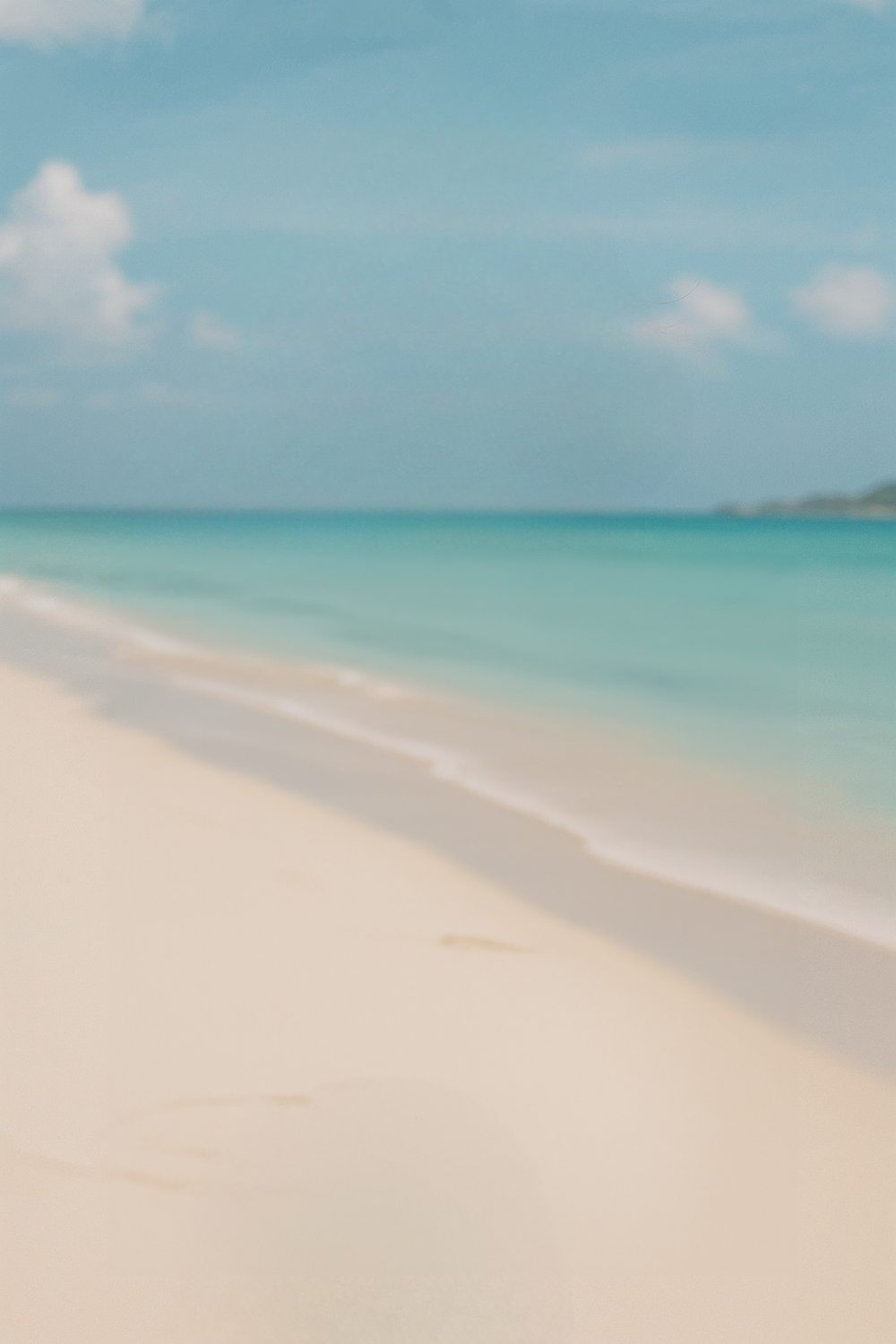 Bright tropical beach with turquoise water and soft sand