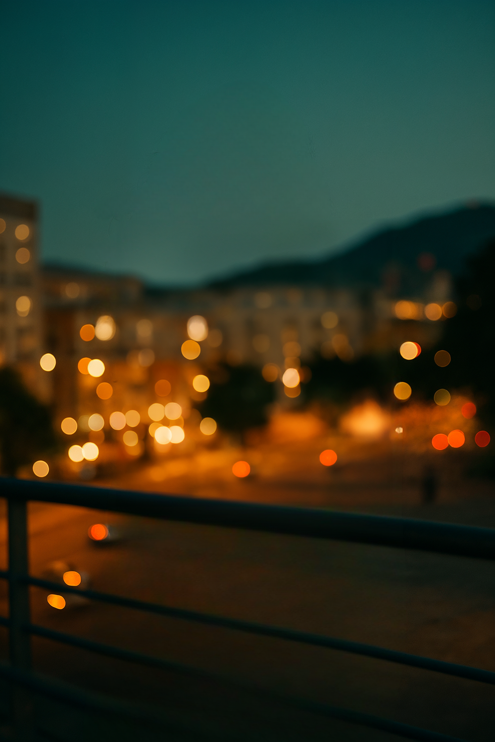 City lights glowing at dusk over mountain skyline