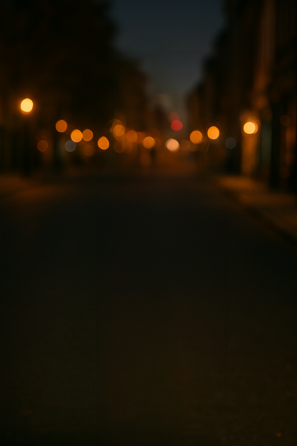 Dimly lit street with warm ambient lamplight glow