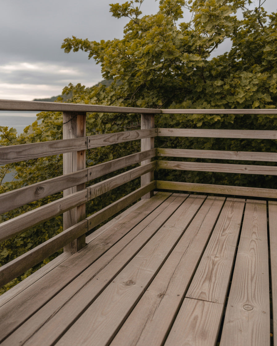 Wooden lookout deck surrounded by green forest views