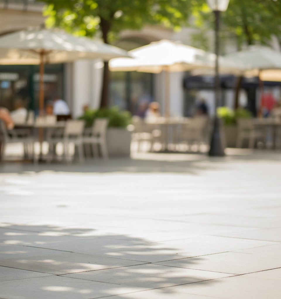 Sunny outdoor café patio with tiled flooring and soft natural shadows