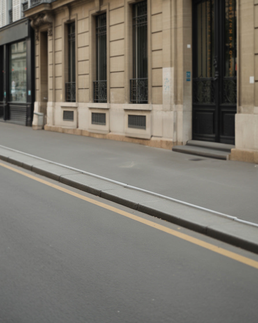 Classic stone building with smooth asphalt road sidewalk