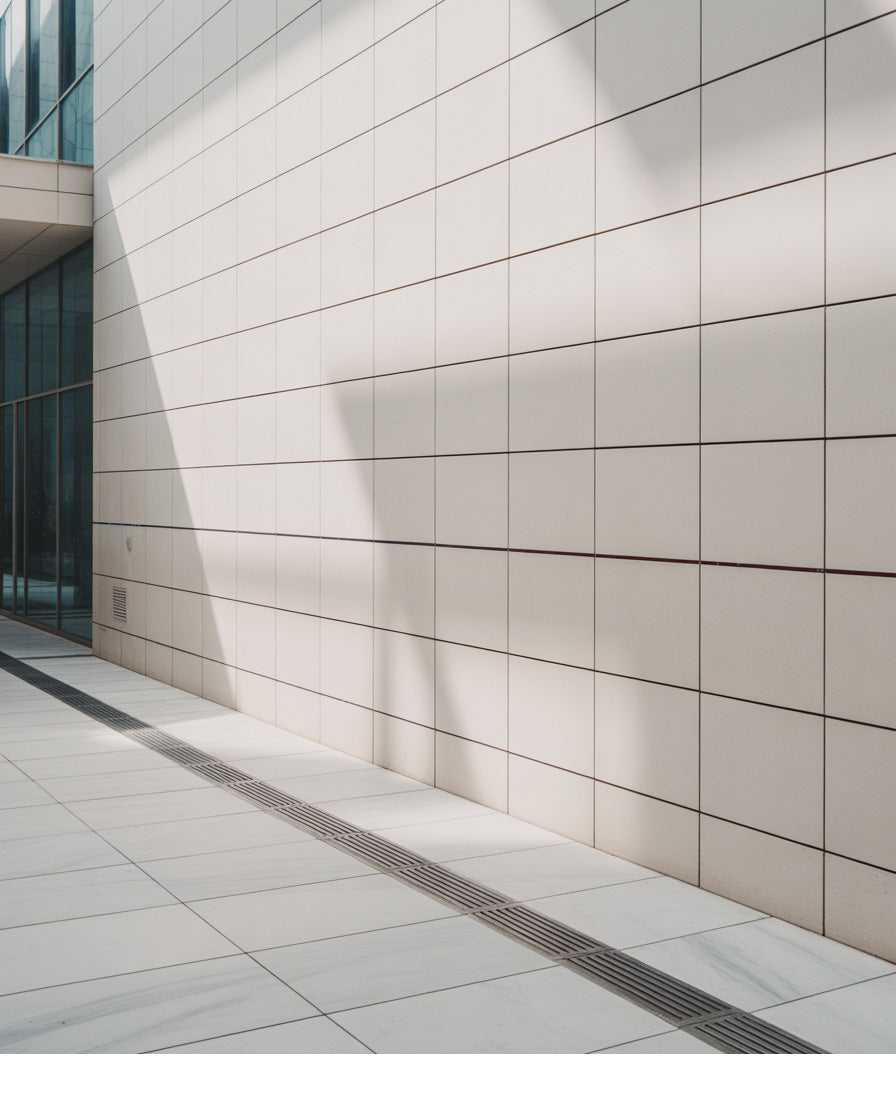 Bright modern tiled courtyard with long angular shadows