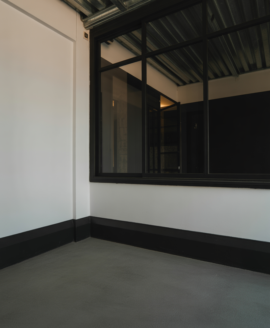 Industrial interior with concrete floor and glass partition