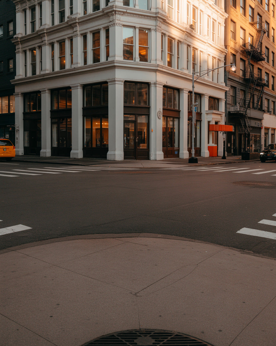 Warm sunset light on classic corner building in quiet city intersection