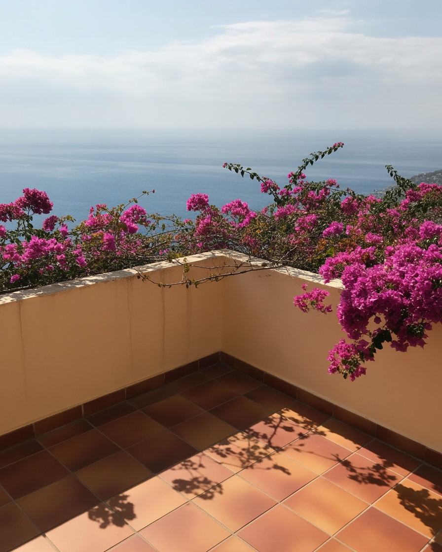 Sunny seaside terrace with blooming flowers and ocean view