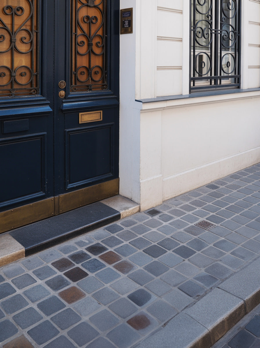 Classic European doorway with wrought iron and cobblestone sidewalk