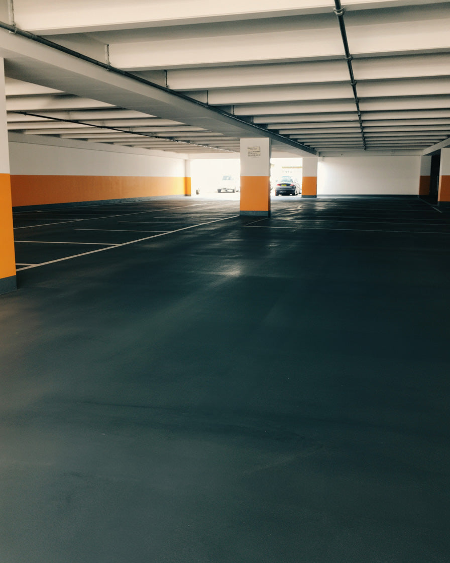Empty underground parking garage with painted columns and soft lighting