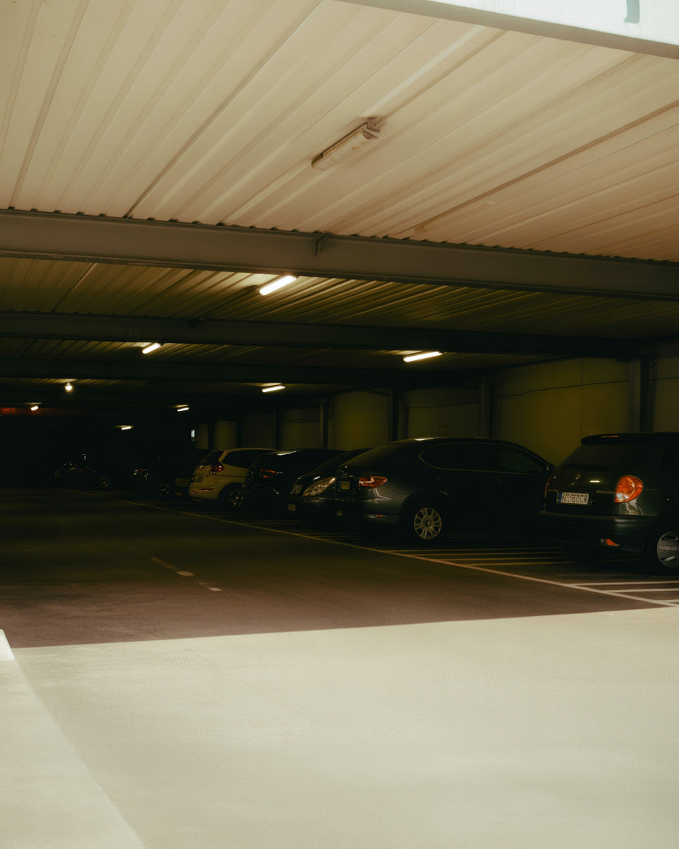 Dim underground parking garage with linear lights and concrete