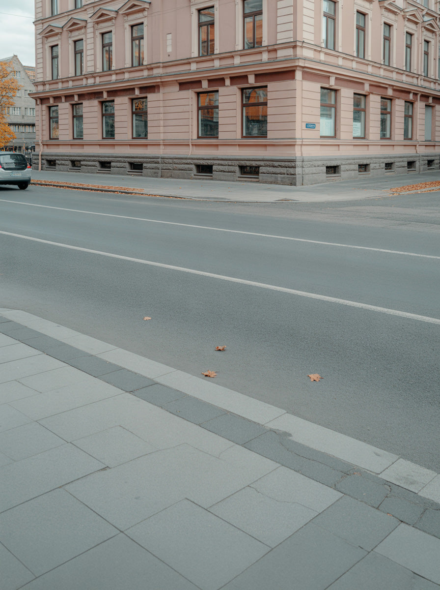 Quiet city street corner beside classic stone building